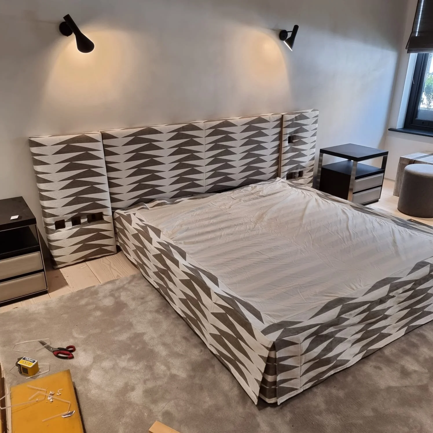 Upholstered bed and headboard with integrated sockets 