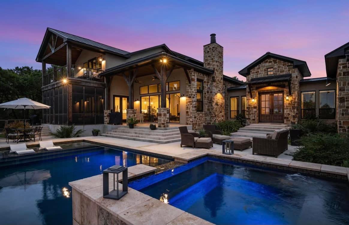 Exquisite Custom Pool & Patio with Water Features and Lighting by WaterStone - Immerse yourself in elegance with our bespoke pool and patio creation in Boerne, Texas. This captivating outdoor oasis showcases expert craftsmanship, custom water feature