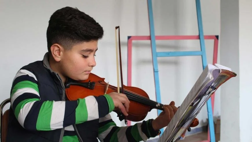 Young participant learning violin through Peace of Art in Lebanon