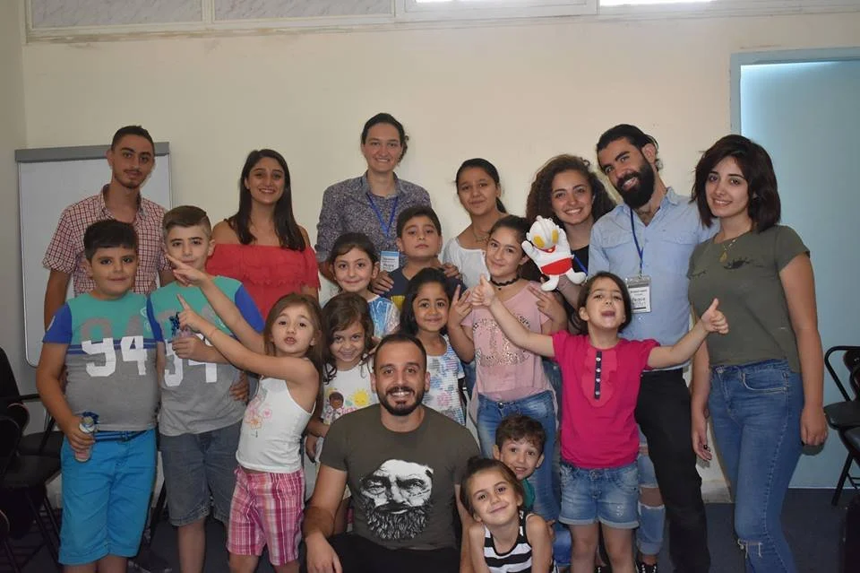 Peace of Art volunteers and children