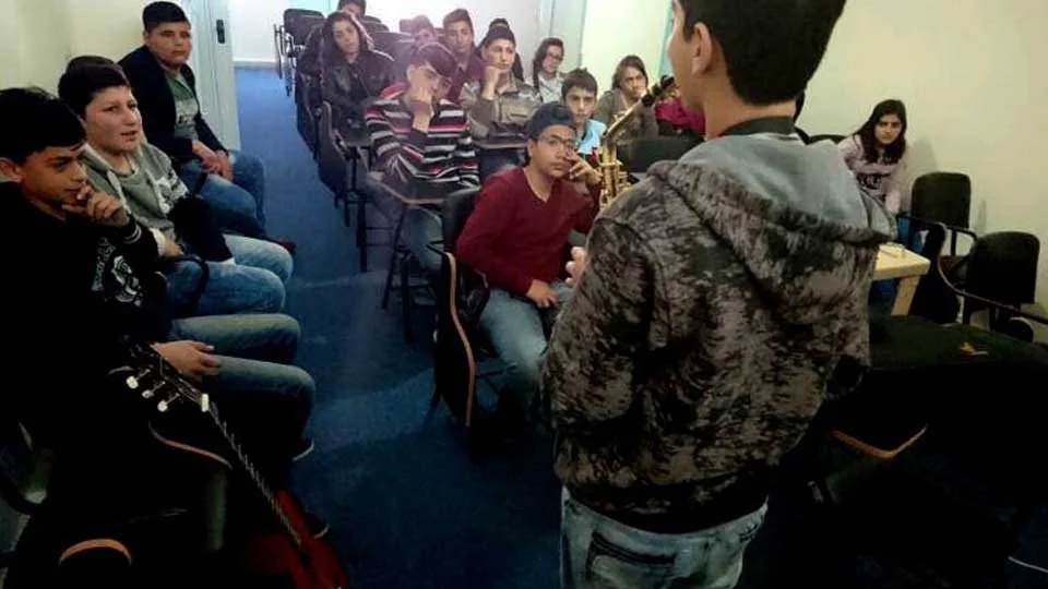 Students attending a free music workshop
