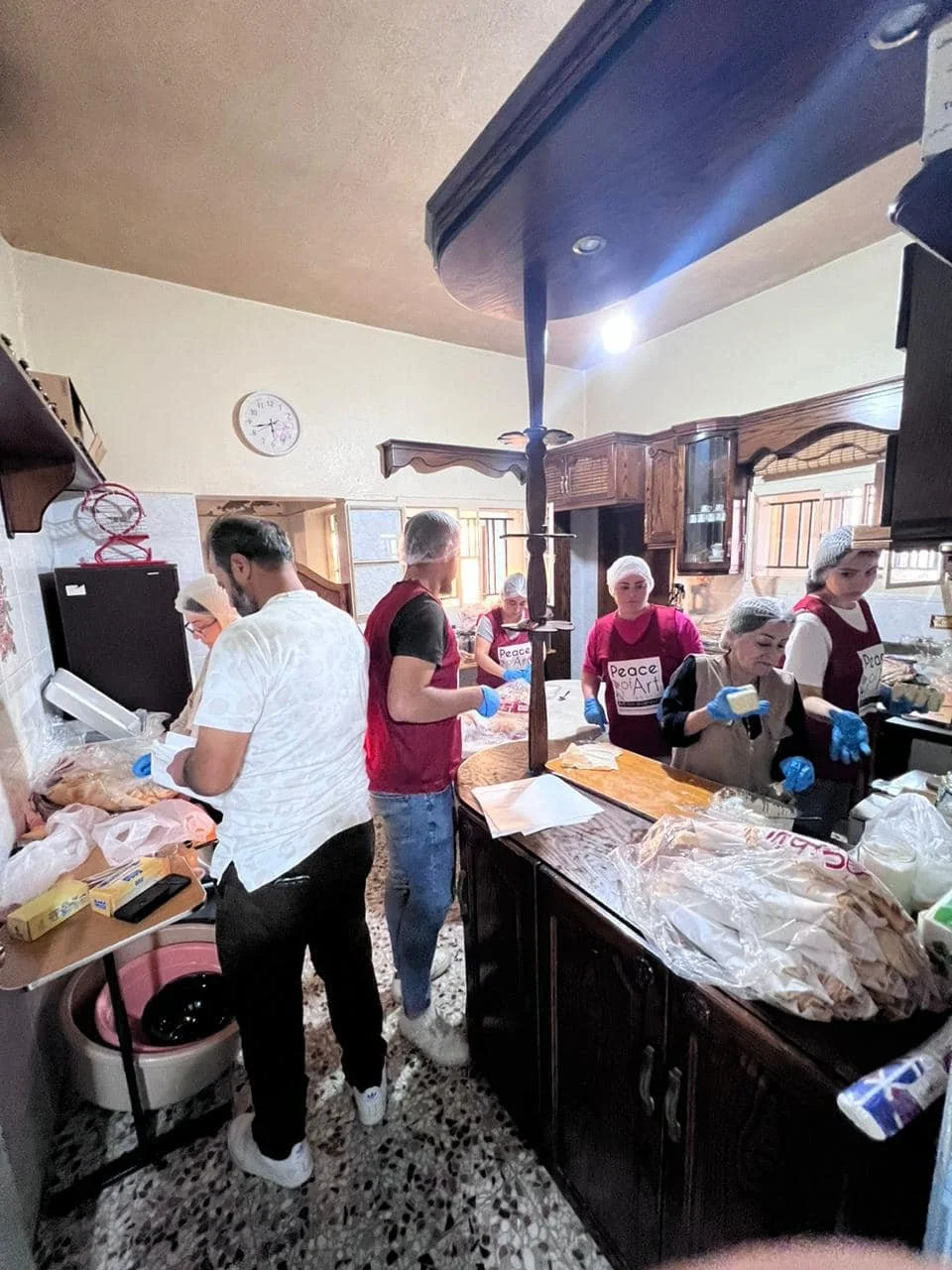 Peace of Art volunteers preparing meals in community kitchen