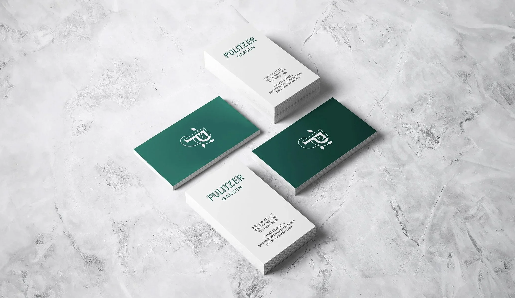 green and white business cards featuring the logo for Pulitzer Garden restaurant in Amsterdam