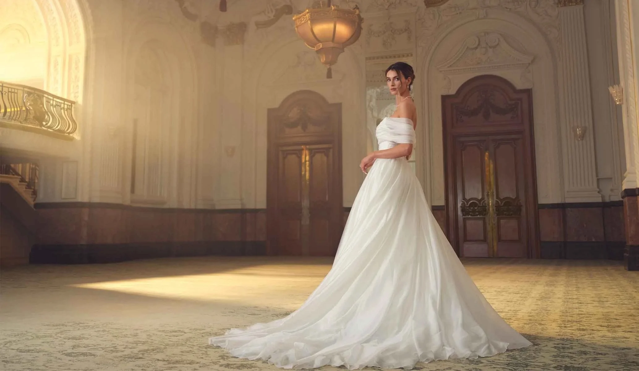 A wedding bride in a long white dress standing in a the ballroom at The Grand, Birmingham, taken as part of the advertising campaign by Colt