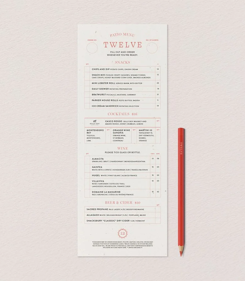 Twelve restaurant patio menu and red pencil, designed to represent the outdoor offer for the brand