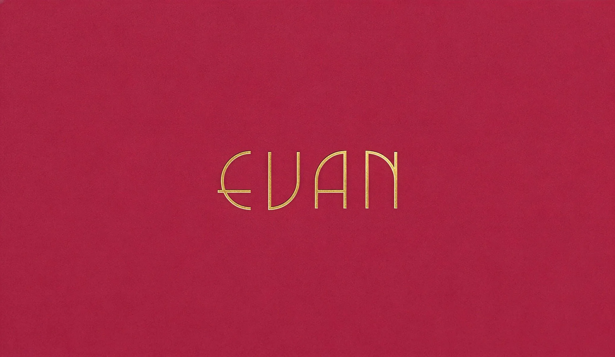 Gold foil blocked wordmark logo on a magenta background for Evan bakery