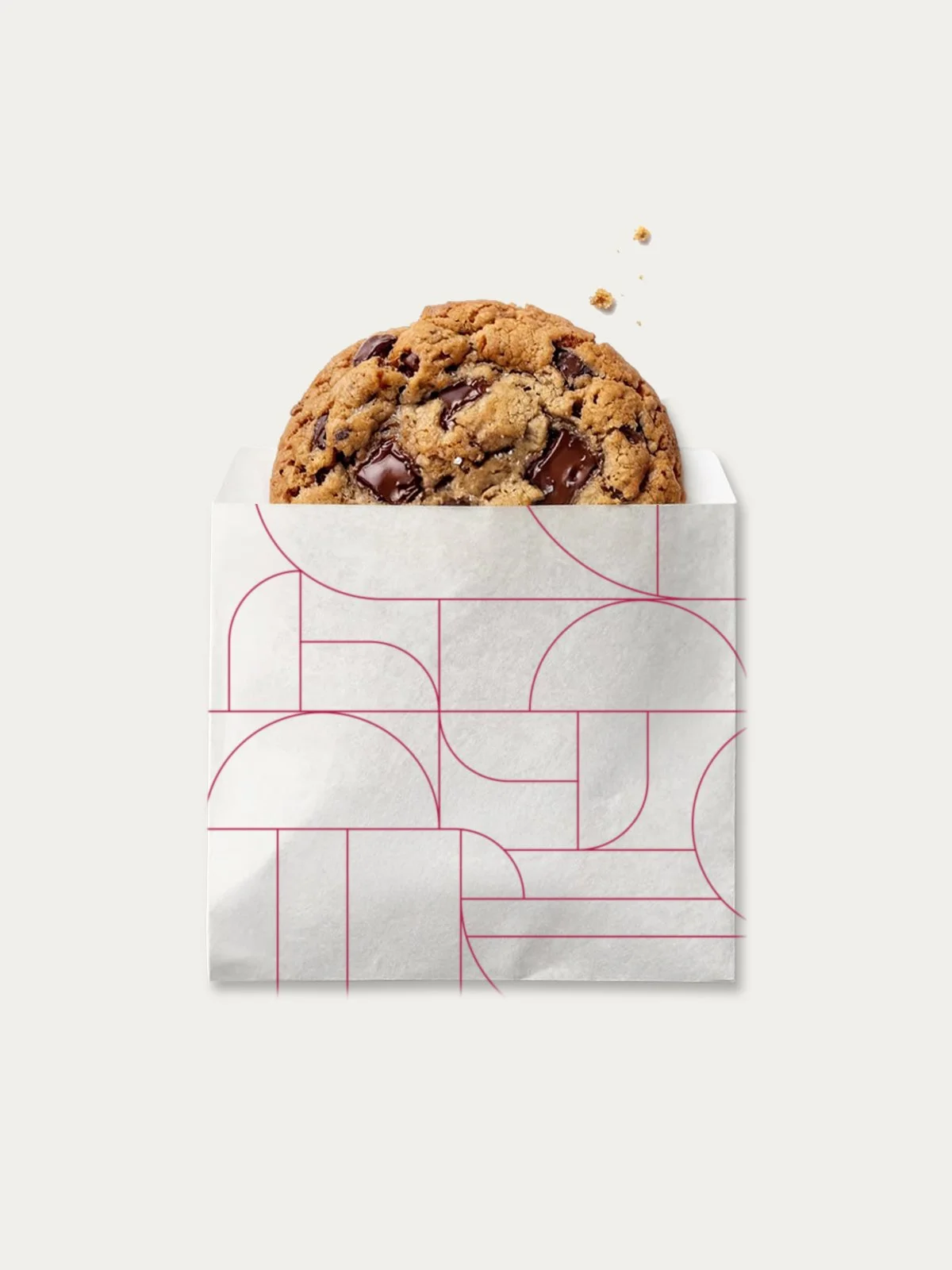 large cookie in white paper bag with art deco pattern