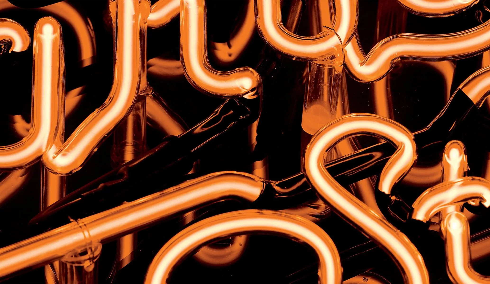 Close up of orange neon light featuring the words 100 wardour st by Colt