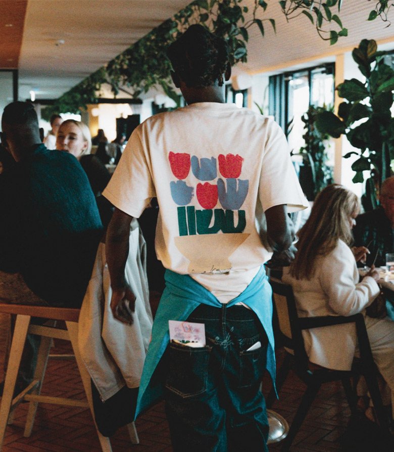 Staff at Kaso bar, Shoreditch wearing branded T-shirt featuring paintings created as part of the brand identity by Colt
