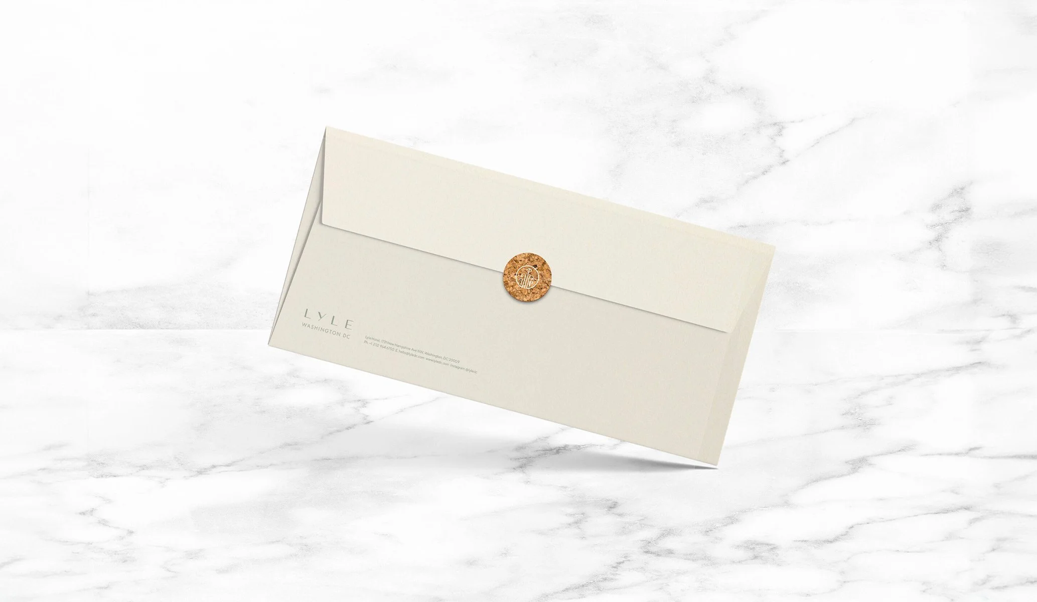 Cream envelope with cork sticker seal and the Lyle hotel logo produced by Colt as part of the brand identity project