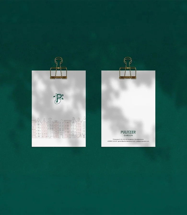 white bill holder featuring an illustration of dutch houses and the logo for pulitzer garden, amsterdam