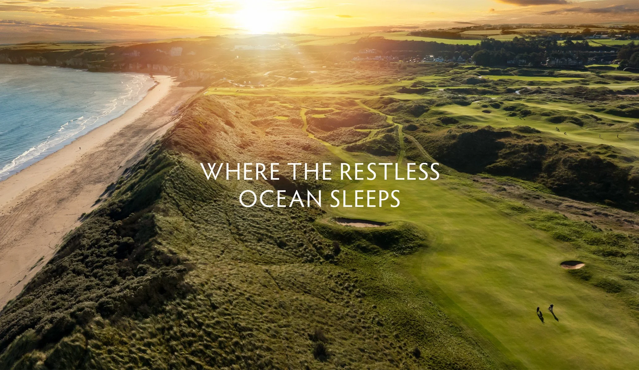 Sunset at Royal Portrush golf course with the strapline for Dunluce Lodge pictured centrally