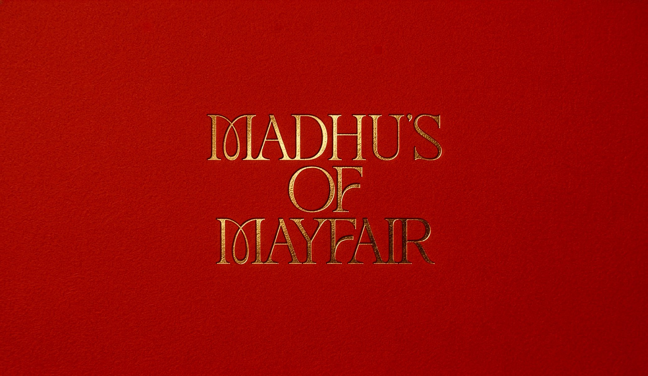 Gold foil blocked logo reading Madhu's of Mayfair by Colt, part of the brand identity for the restaurant in London