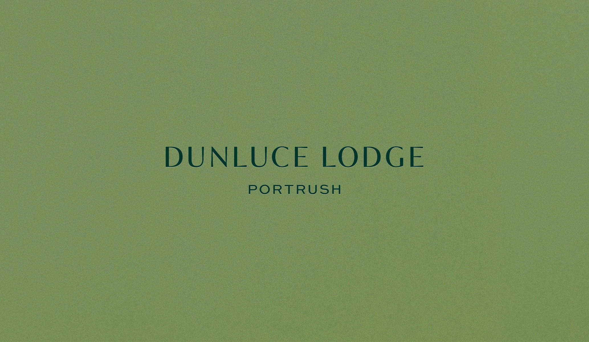 Logo for Dunluce Lodge hotel in dark green on a mid-green background