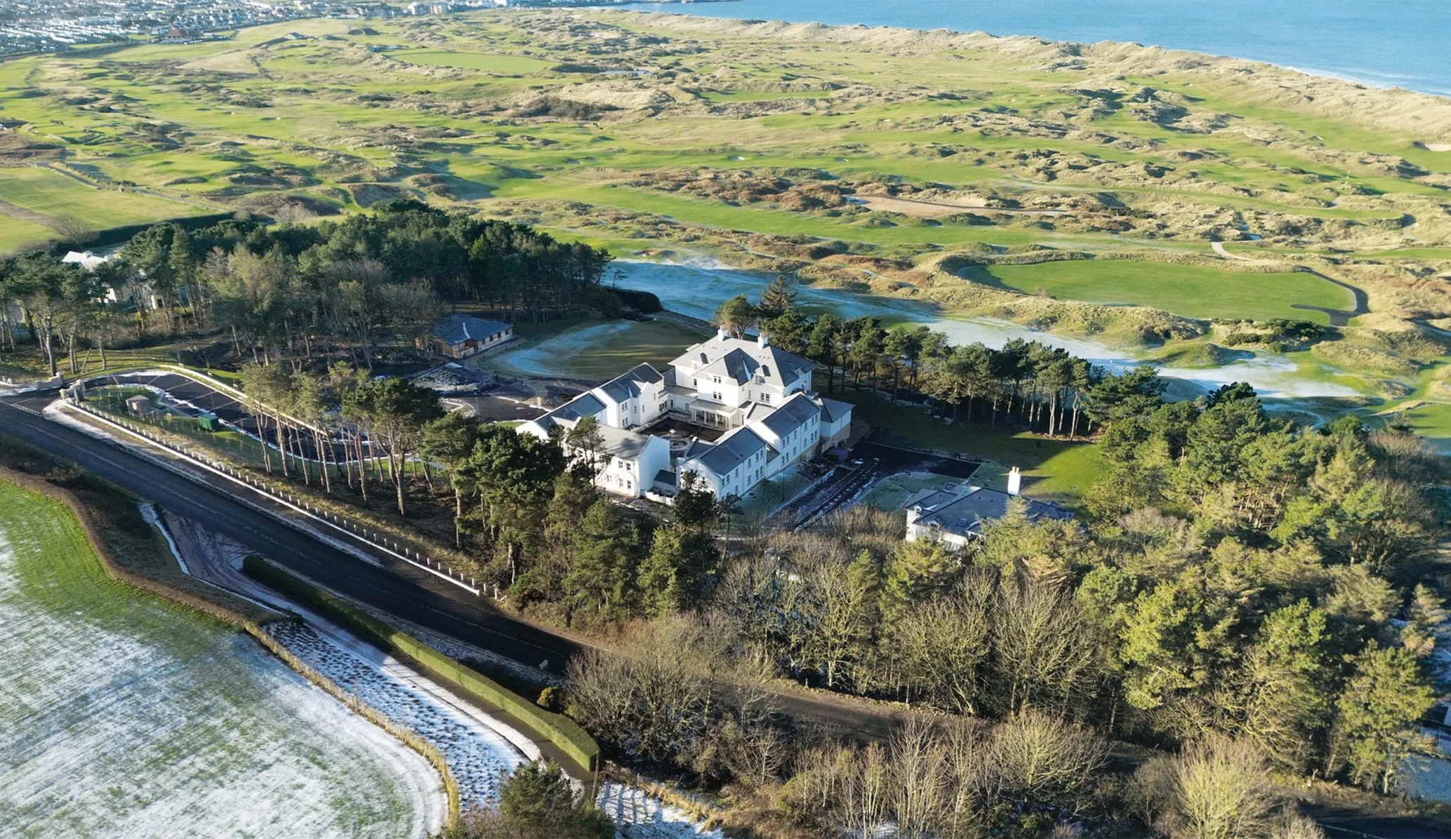 drone view from above of Dunluce Lodge hotel beside Royal Portrush golf course in Northen Ireland