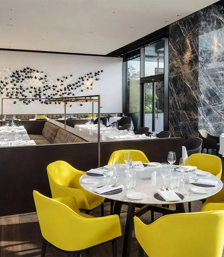 Interior design featuring bright yellow chairs for Duke restaurant in Istanbul, created in line with the brand identity by Colt