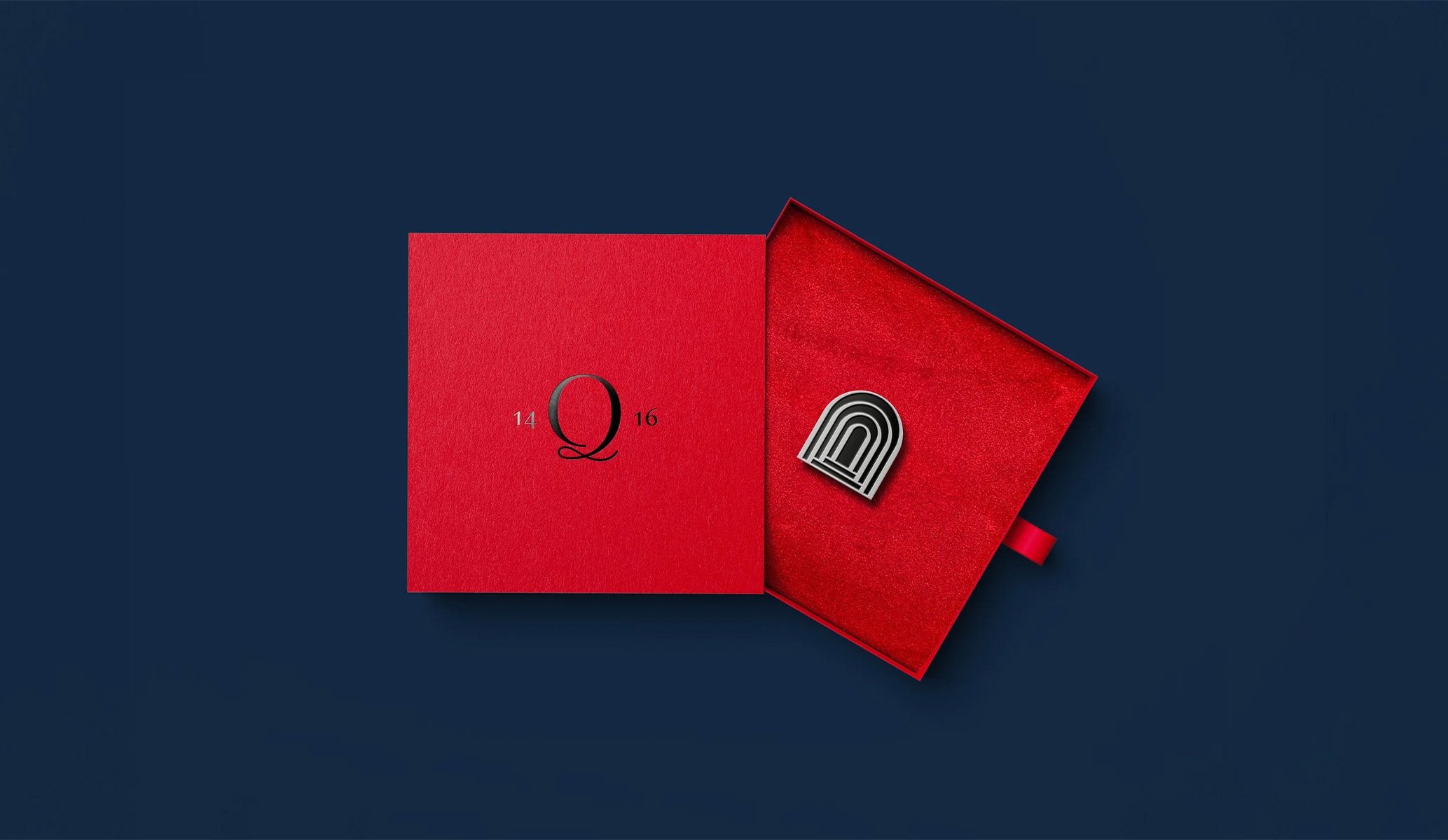 red packaging with black foil block containing a staff lapel badge for Quindici bar at Campari HQ, London