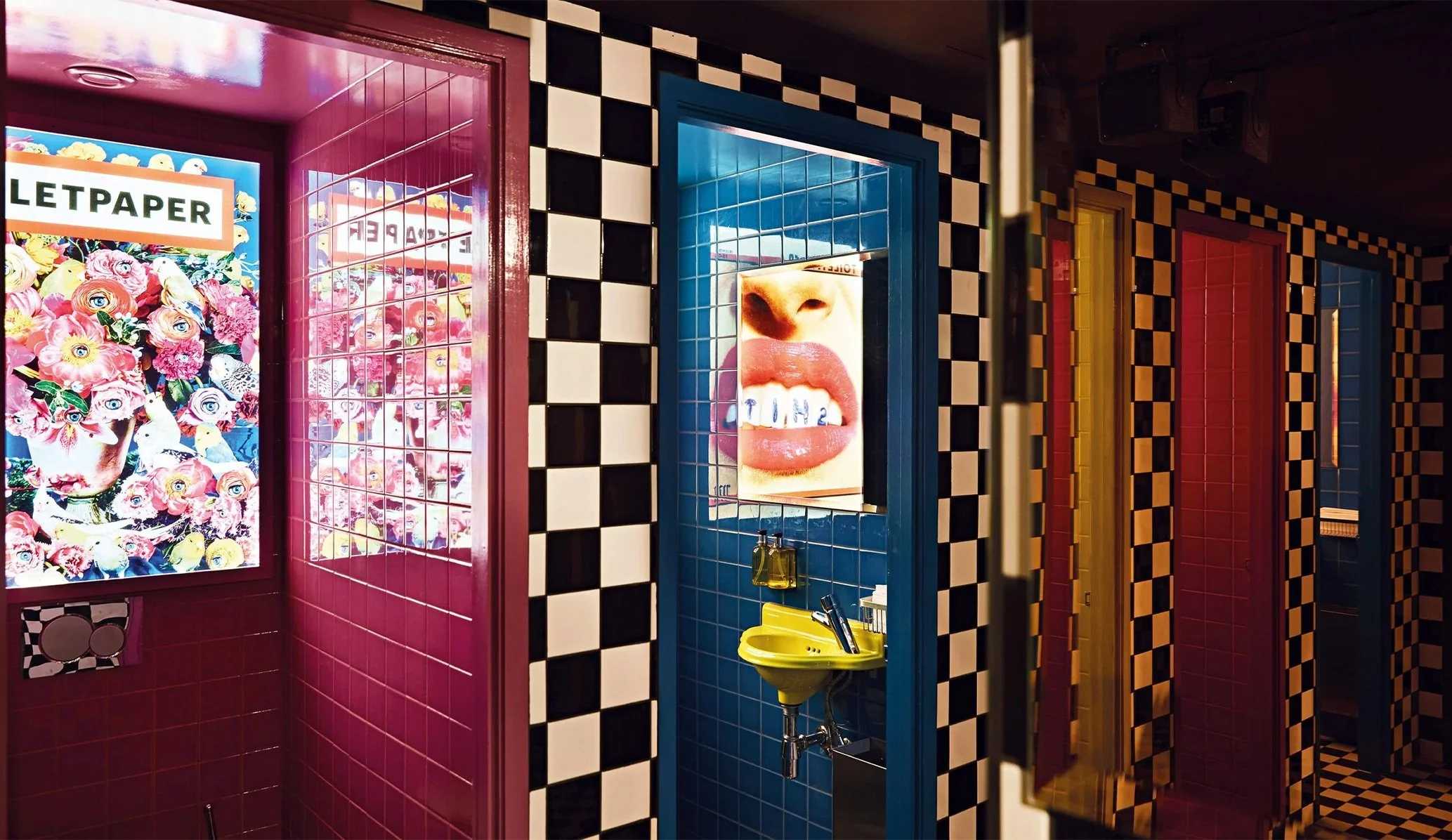 toilet cubicles in black and white tiles and brightly coloured tiles at 25 Paul St bar