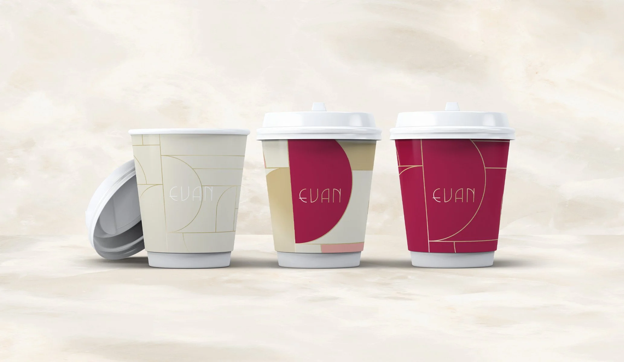 three takeaway coffee cups for Evan Bakery in Al Ain featuring different art deco inspired patterns