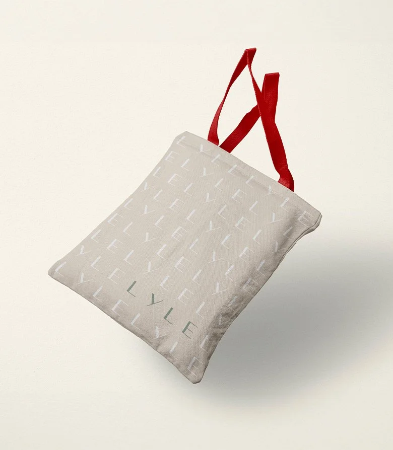 Cream tote back featuring a repeating pattern and the logo for Lyle Hotel in Washington designed by Colt