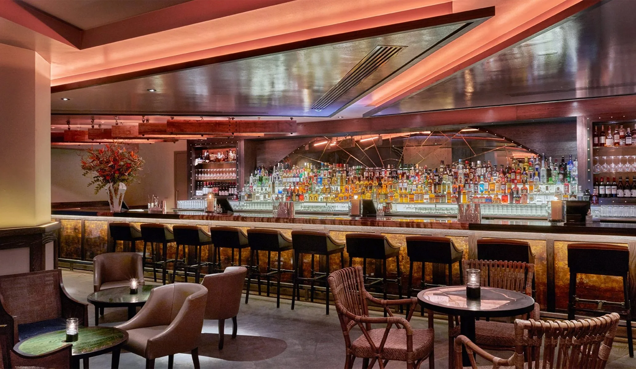 large bar space featuring tables, chairs and lighting at 100 Wardour St, Soho, London