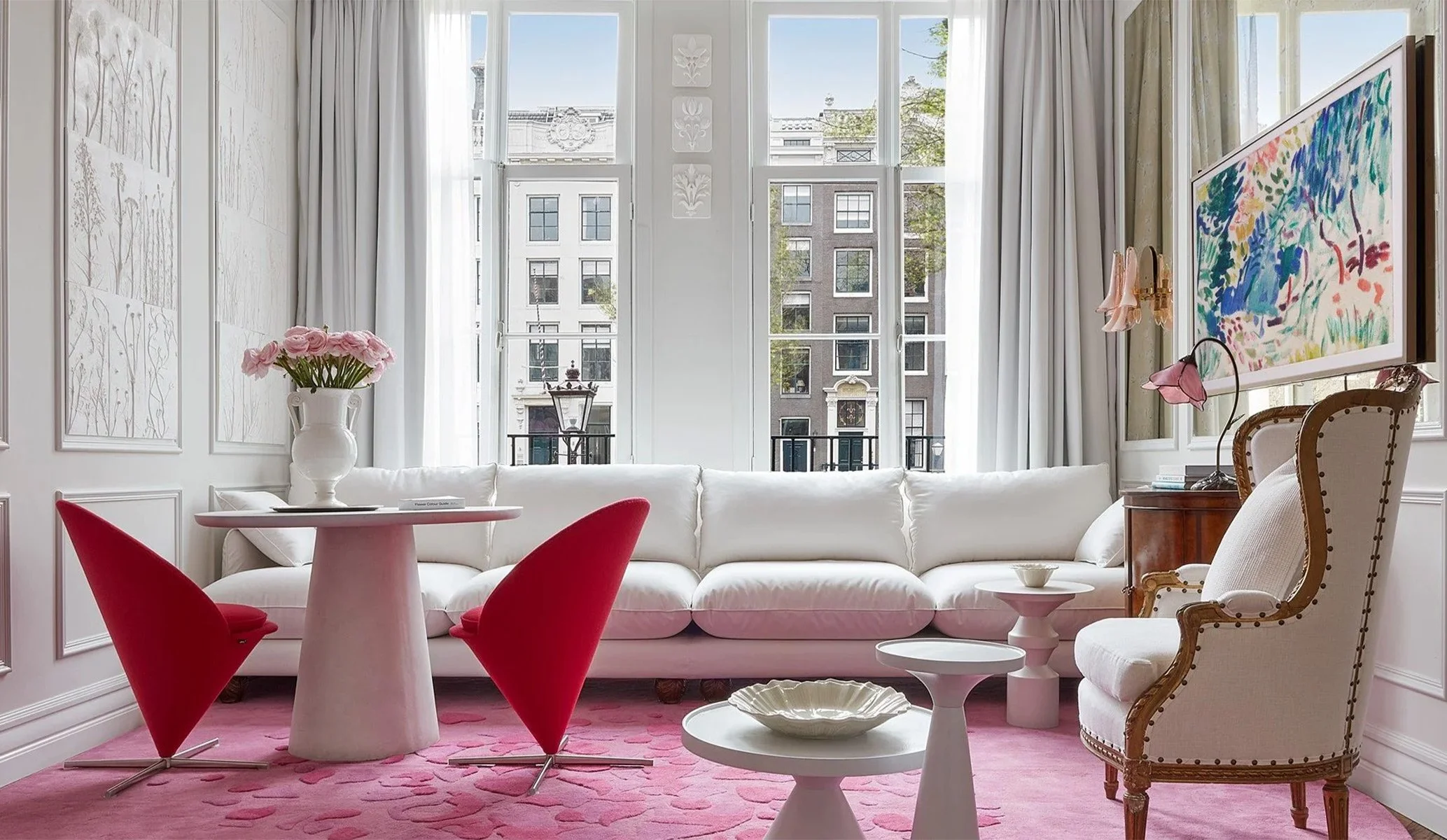 Suite interior with red art deco chairs at Pulitzer hotel in Amsterdam
