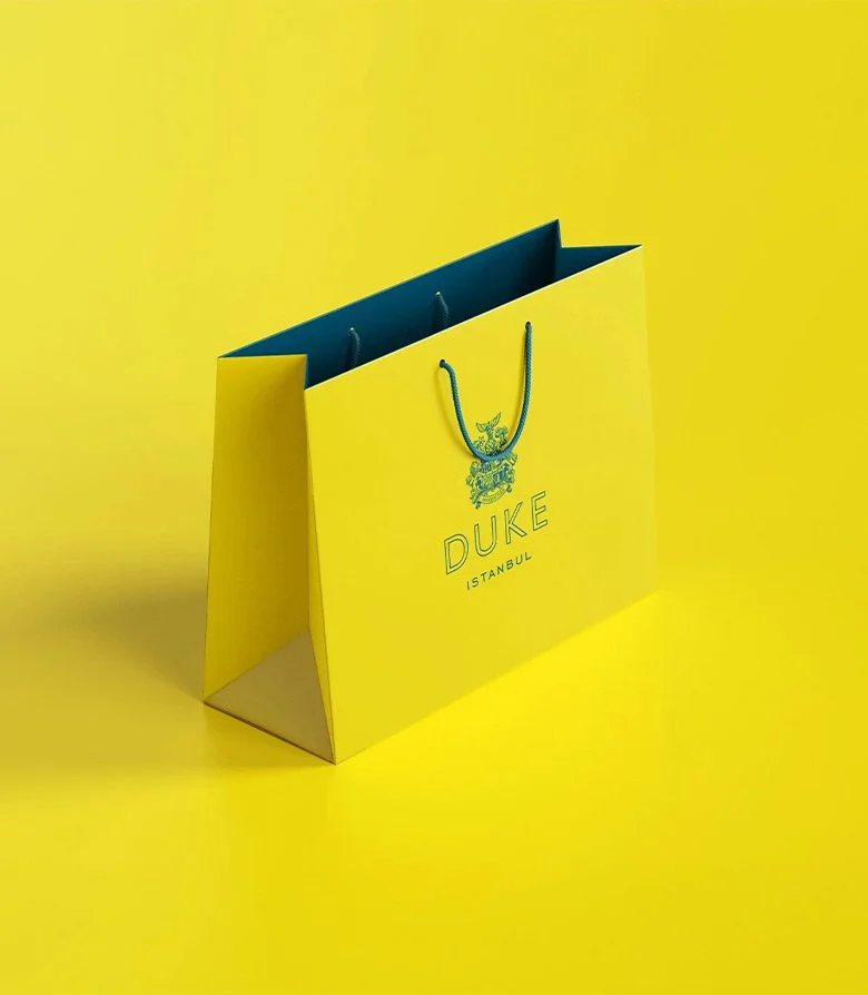 Luxury, card bag in bright yellow for Duke restaurant in Istanbul, created as part of the brand identity by Colt