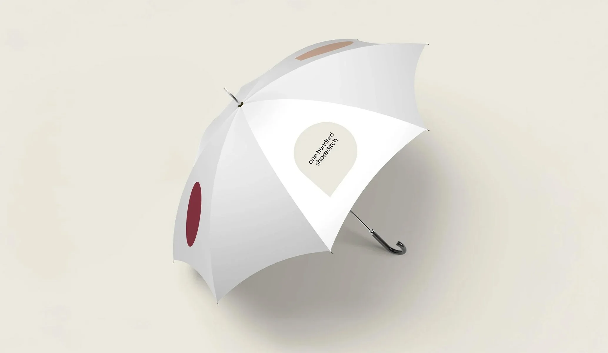 white umbrella for One Hundred Shoreditch created as part of the suite of collateral when applying the new brand identity by Colt