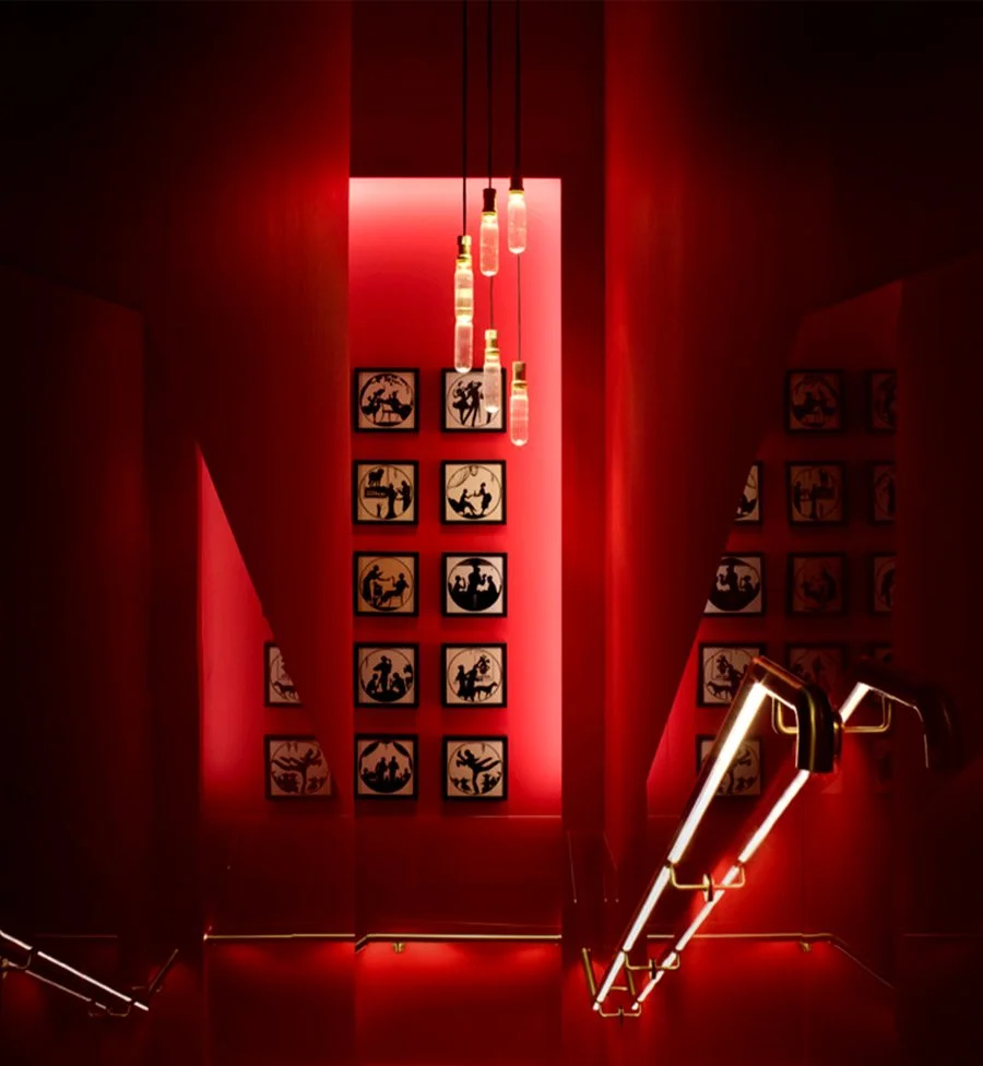 Red staircase leading to the hidden Quindici bar at Campari House, London.