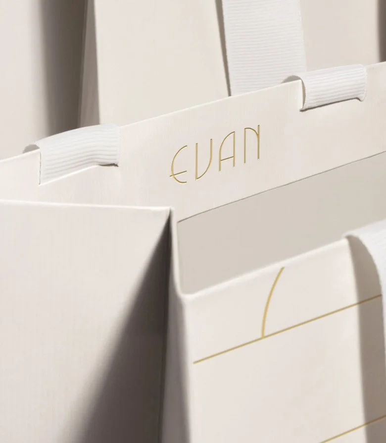 close up of inside of luxury white paper bag with gold foil blocked Evan logo