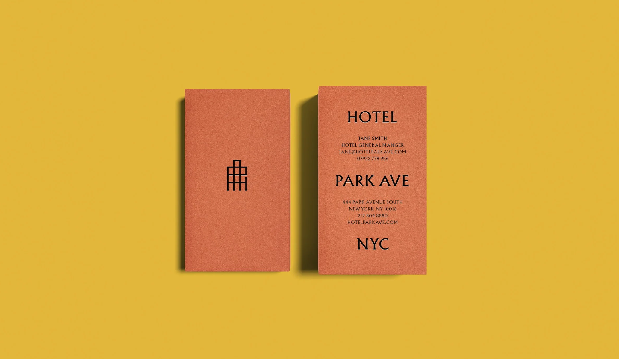 Orange business cards on a yellow background, created as part of the brand identity by Colt