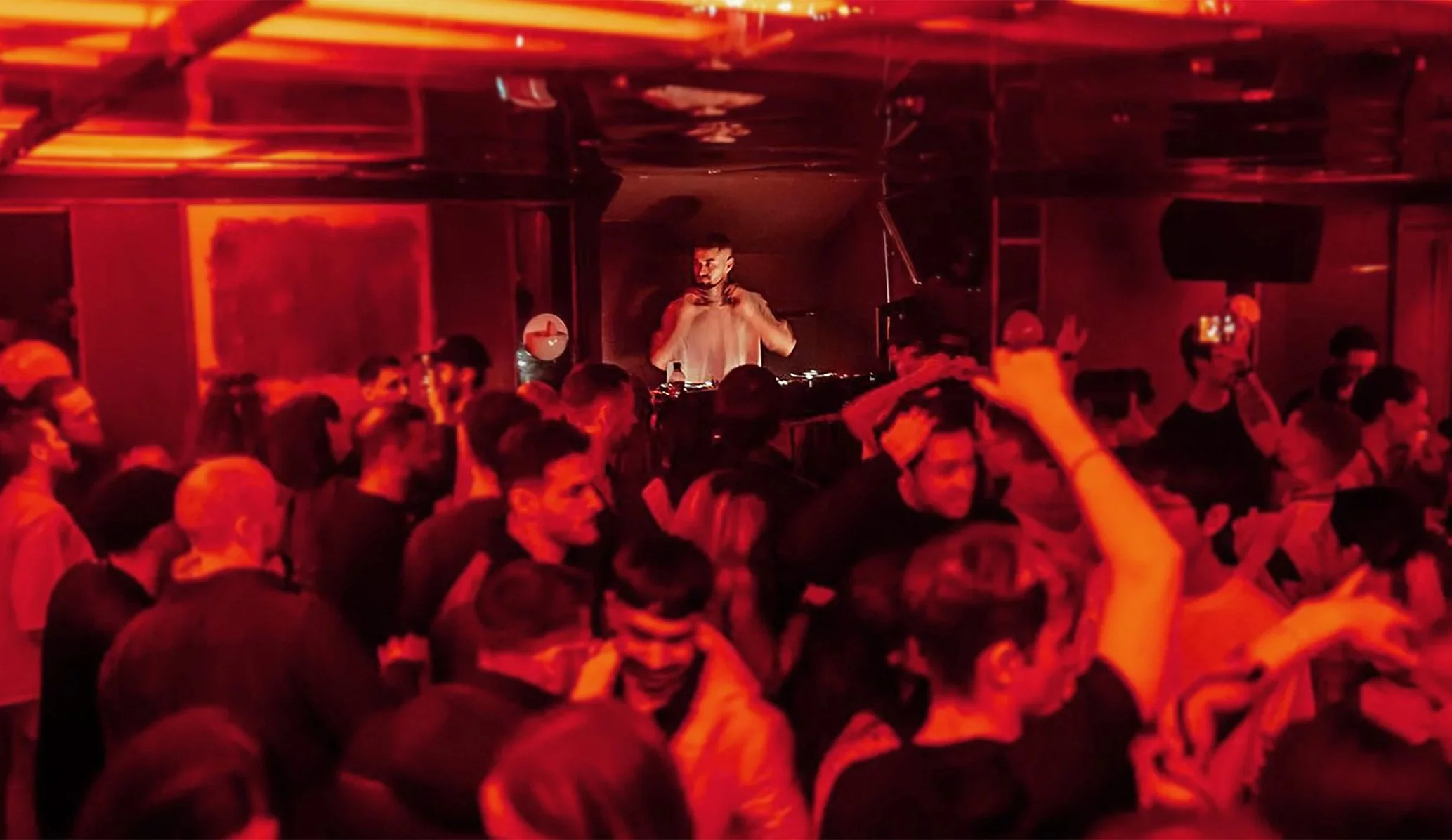Dj in a crowd of people on the dancefloor at 25 Paul St, Shoreditch