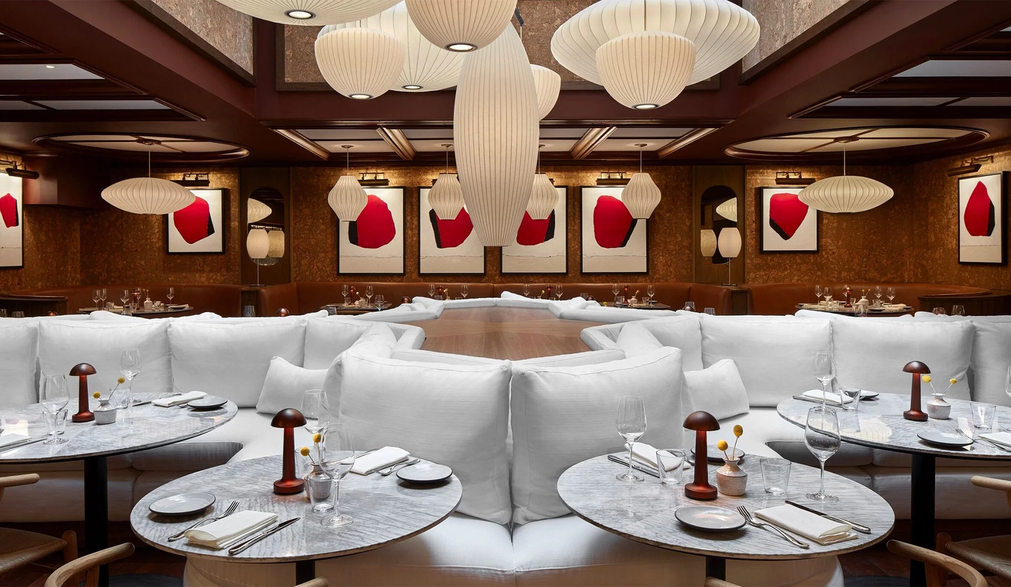 Interior design at Lyle's Restaurant in Washington DC featuring large canvases with red details