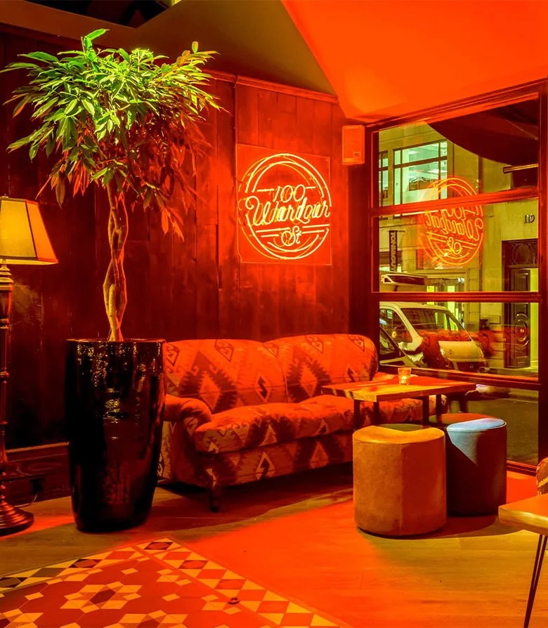 Interior of 100 Wardour St featuring an orange neon light