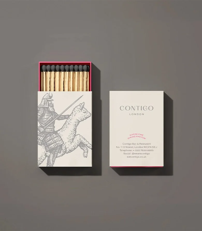cream match box with illustration on the cover and pink inner tray