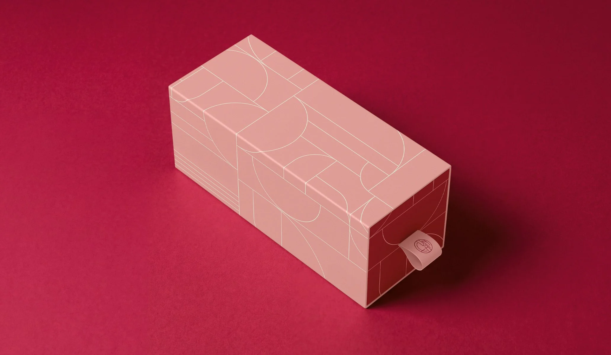 a cake.cookie box in light pink of a darker magenta background featuring art deco pattern linework