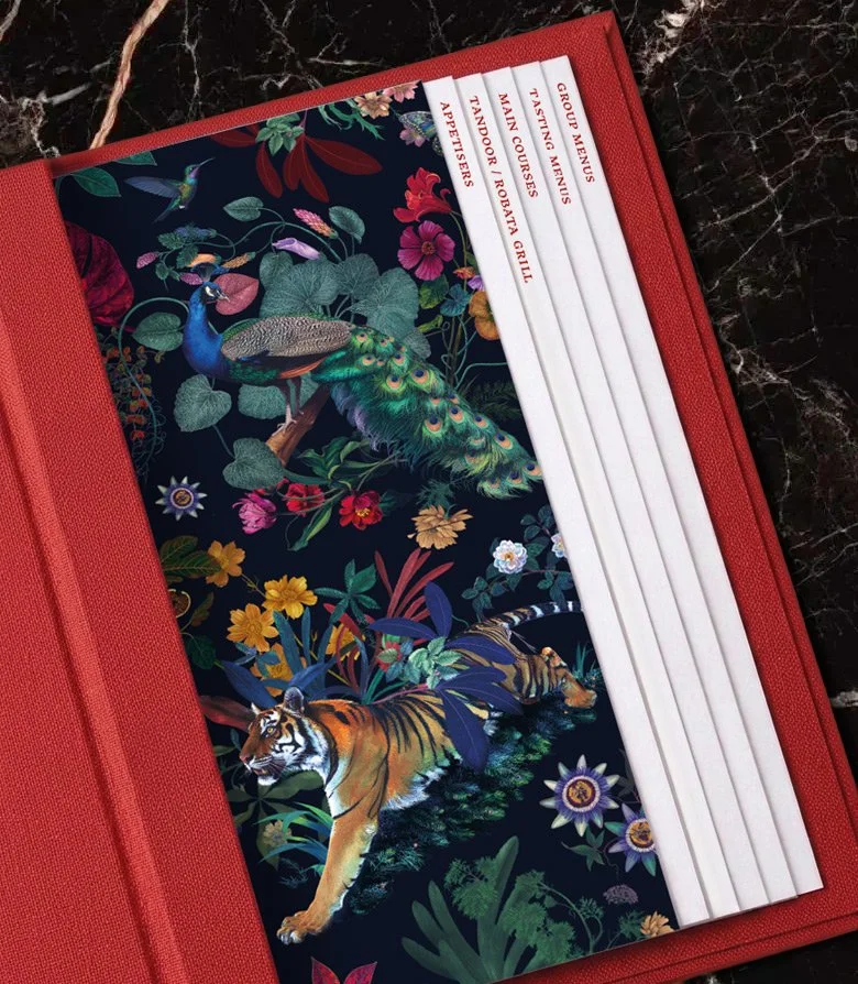 Close up of a red menu cover for Madhu's of Mayfair restaurant produced as part of the brand identity created by Colt