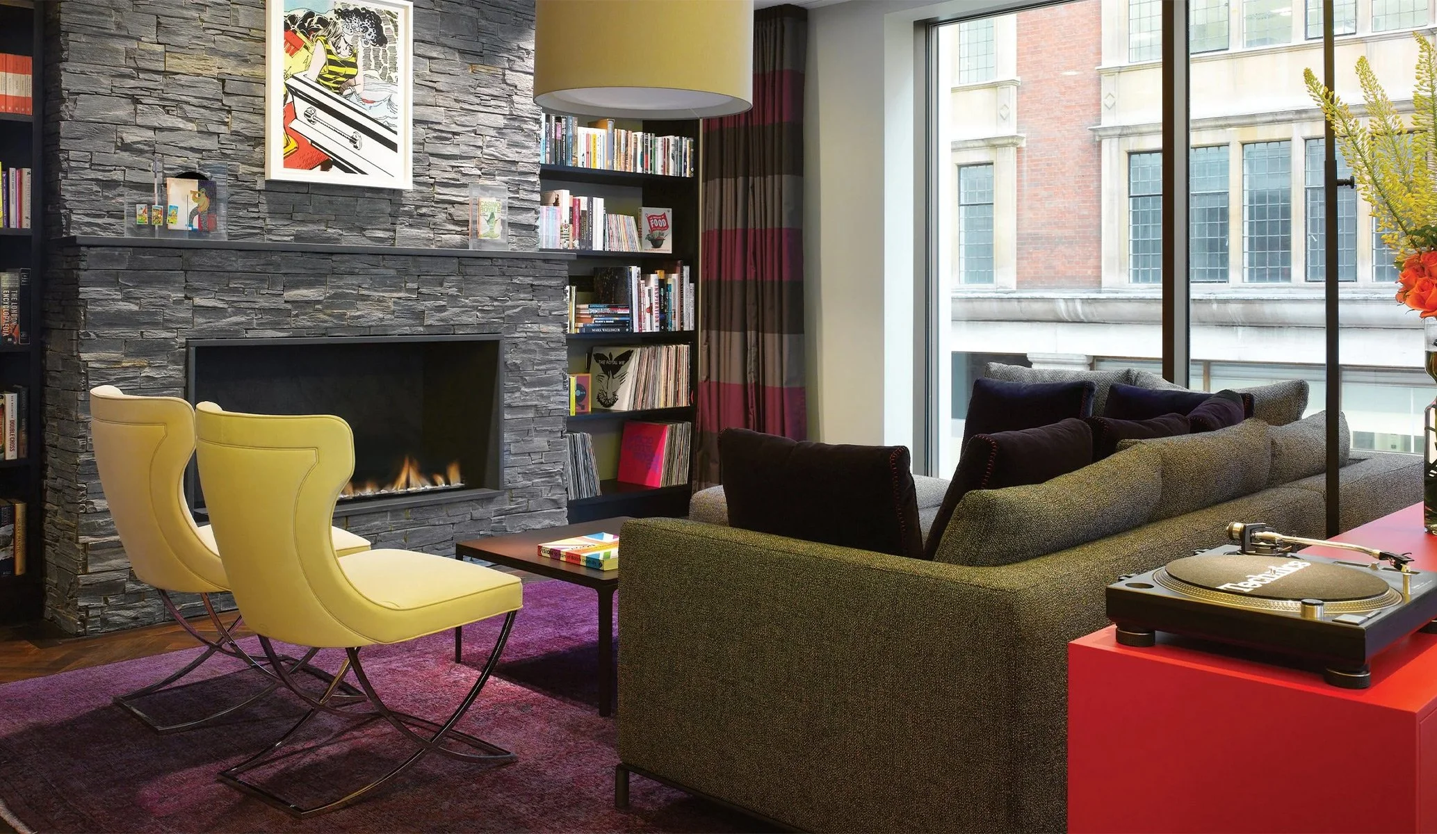 interior design featuring yellow armchairs, fireplace and red sideboard at Club at South Place Hotel, London