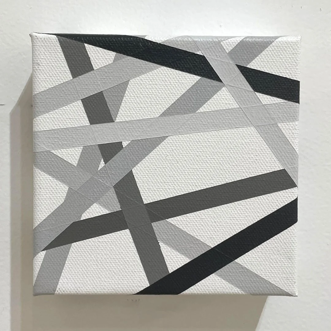 intersecting grey, black, and white ribbons on a white background