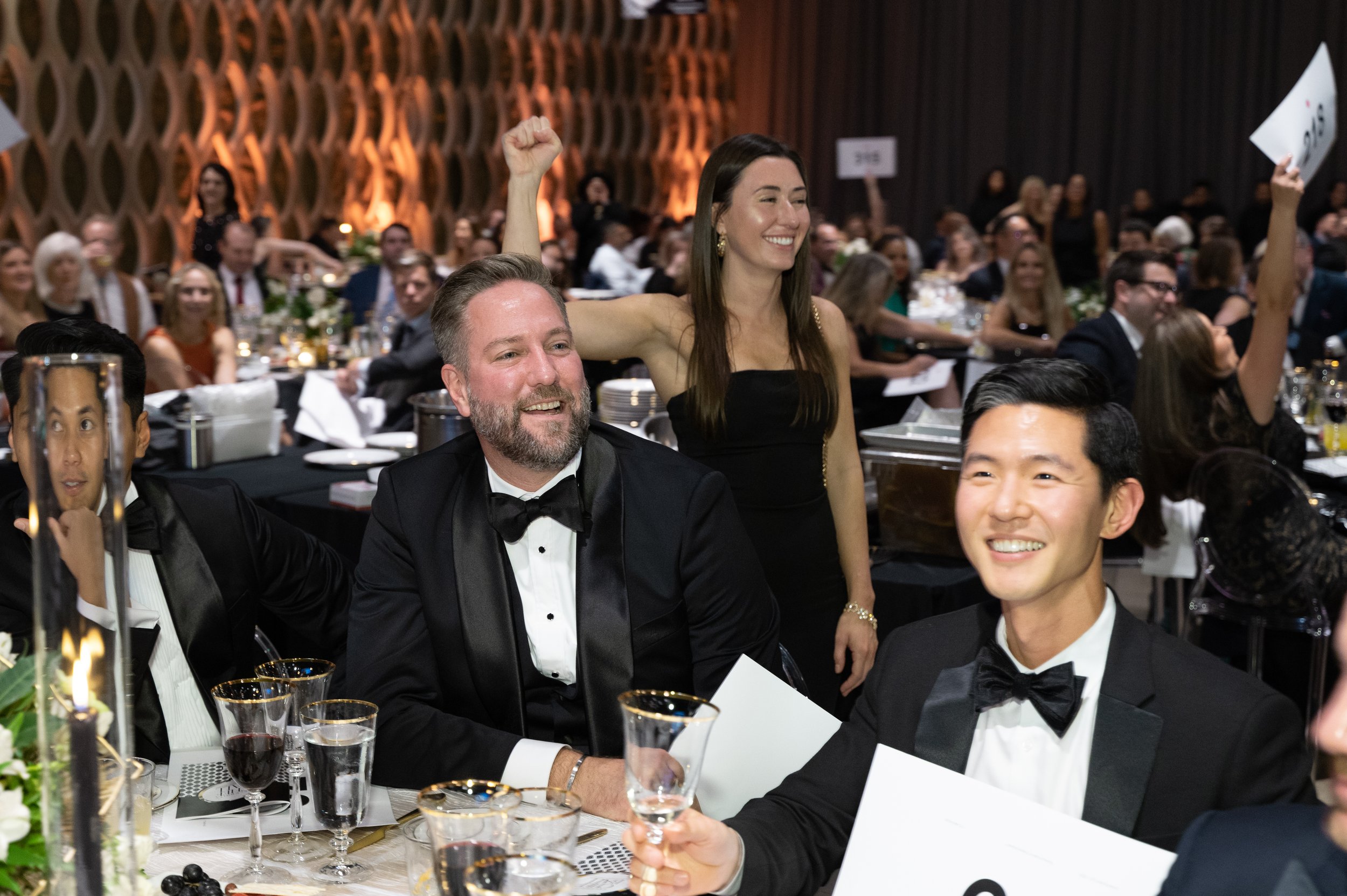 Guests sit at tables and participate in a silent auction for Celebrity Chef Ball.