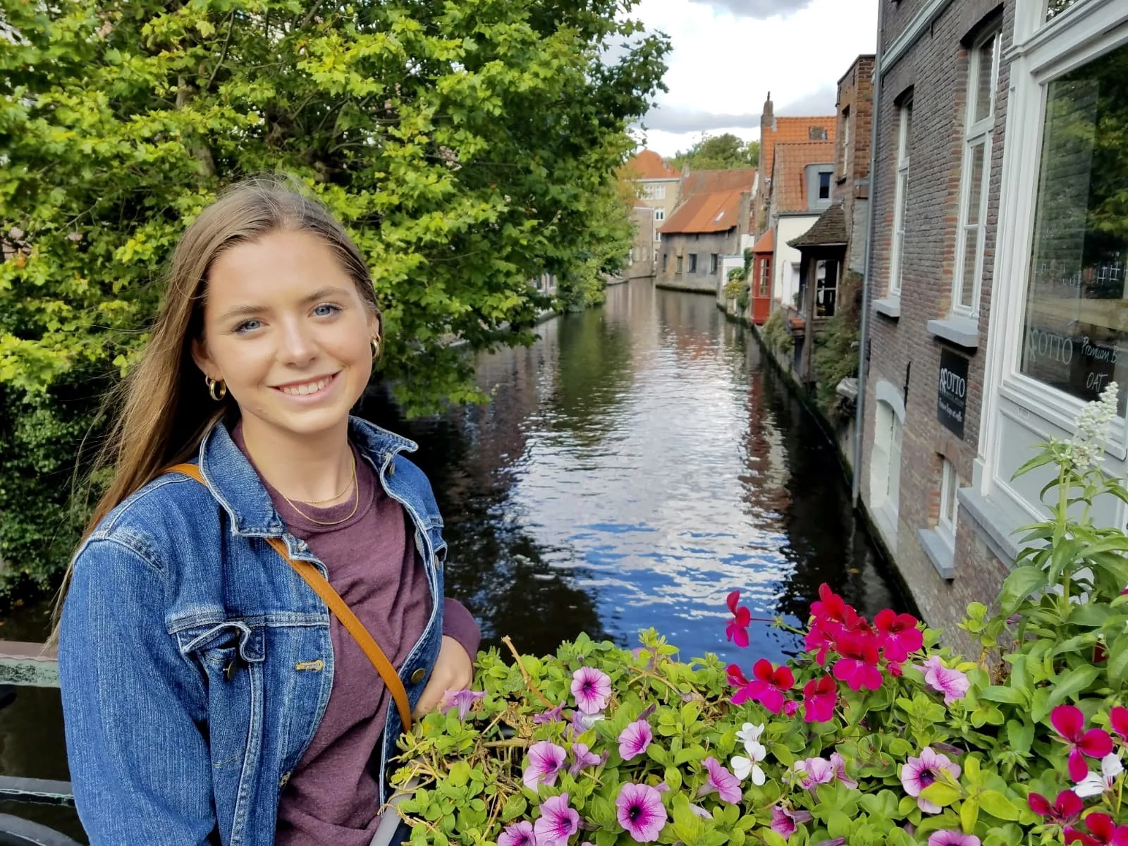 Sydney Leemhuis, Denver photographer and founder of Squid’s Ink Media posing by a canal in Belgium.