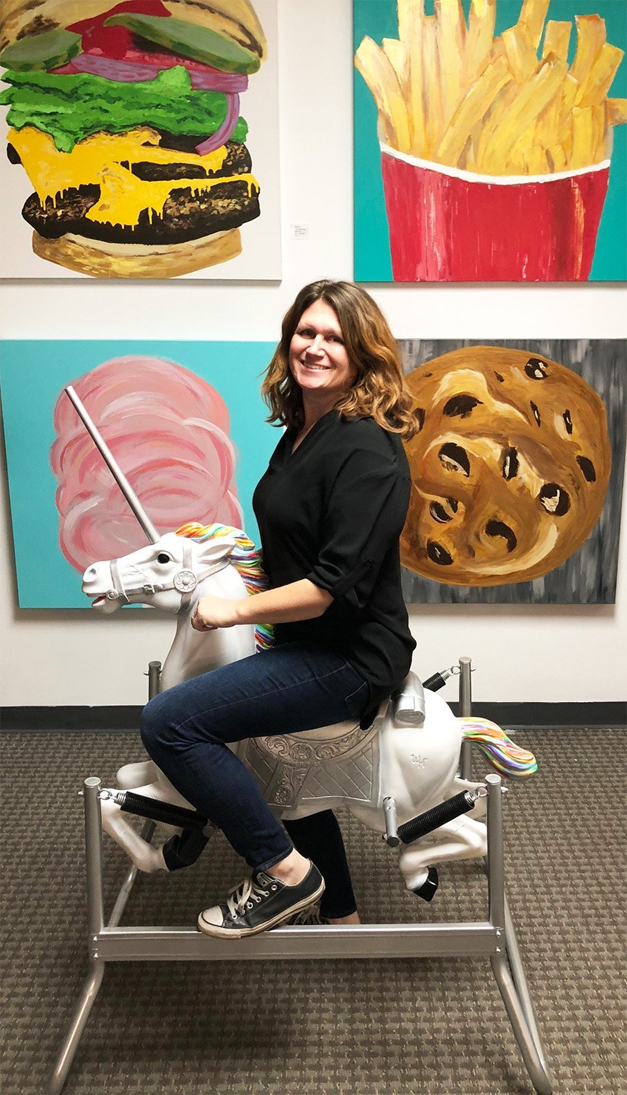 Artist+Martha+Valenta+rides+_The+Commute_+in+front+of+a+wall+of+Pop+Art+works-best-sm.jpg