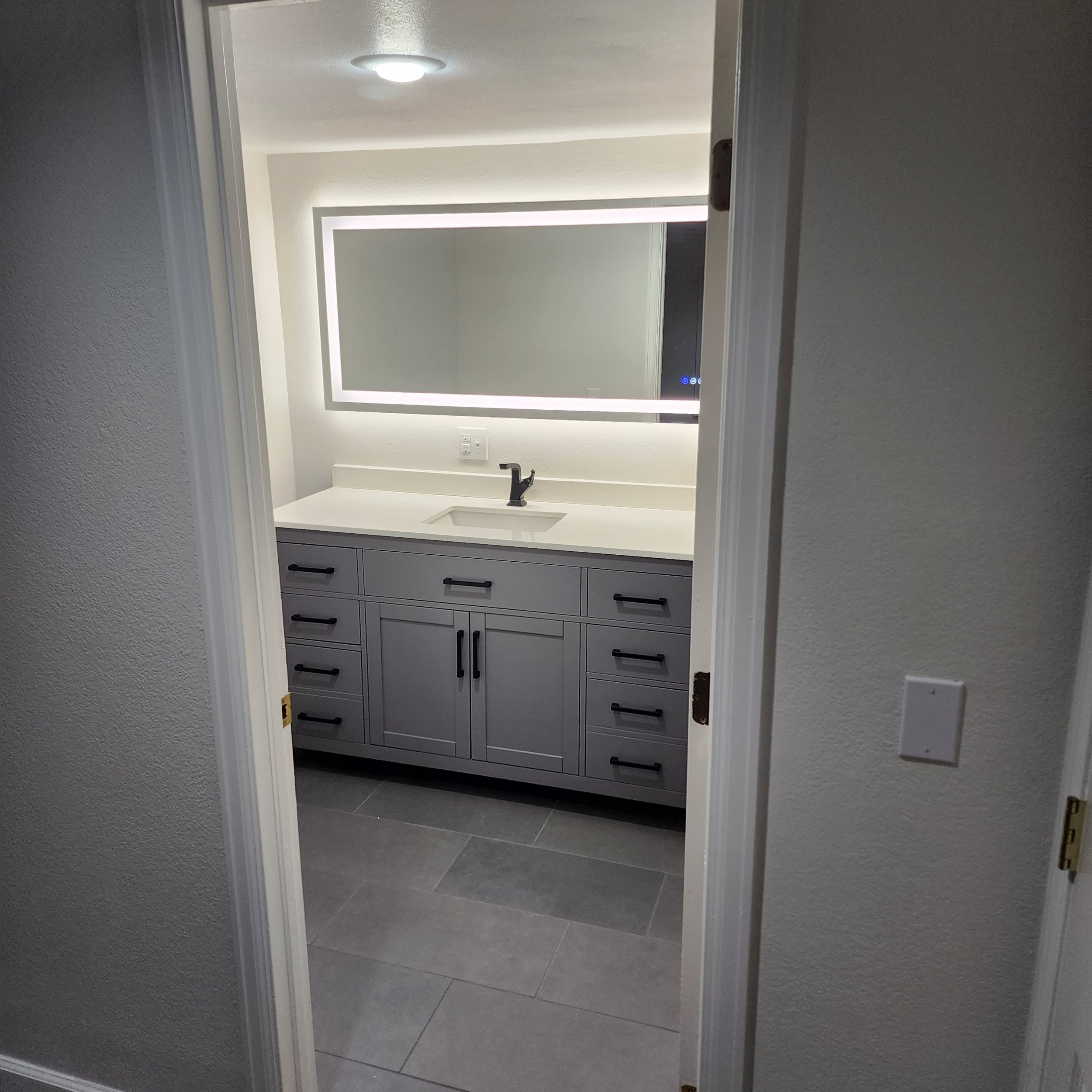 Tiled bath after with LED vanity light