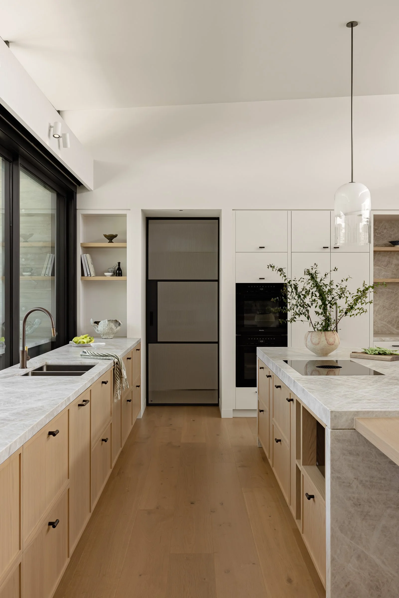 Modern coastal kitchen design with natural stone island