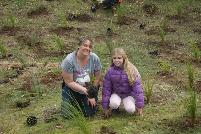 A family from our community helping us plant—ka pai!