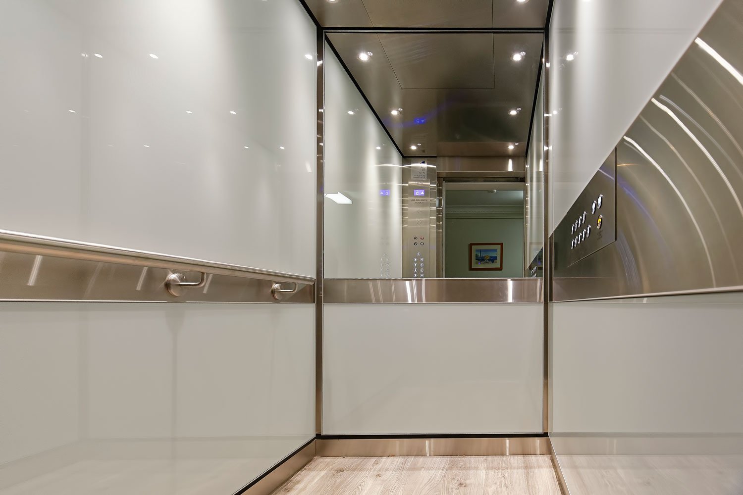  Sleek and modern elevator with white and mirror interior 