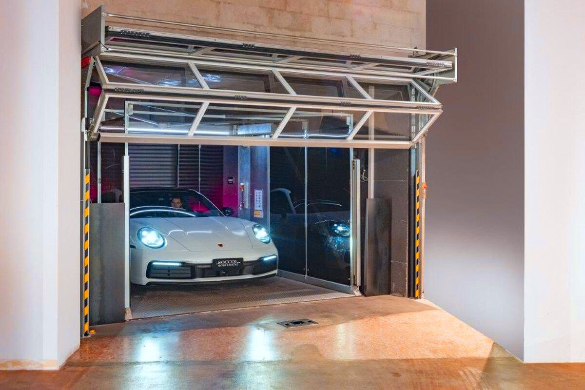  Car lift with porsche coming out of it.  