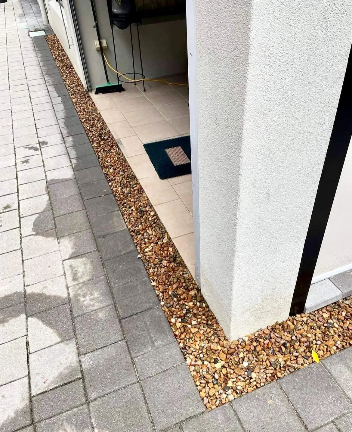 Pavers pulled out and stones added near property wall by Local Dad Lawn & Garden for a client in Palm Cove, Cairns