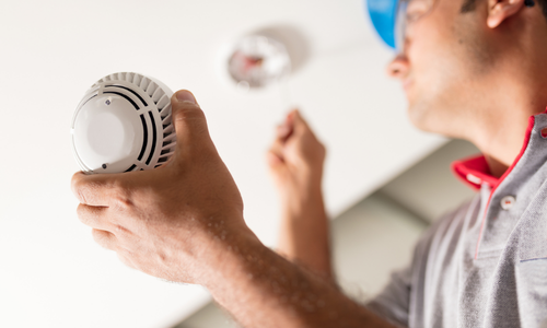 Man installing smoke detector