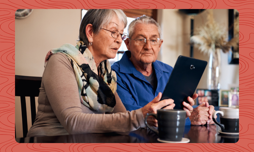 Older adult couple looking at tablet device